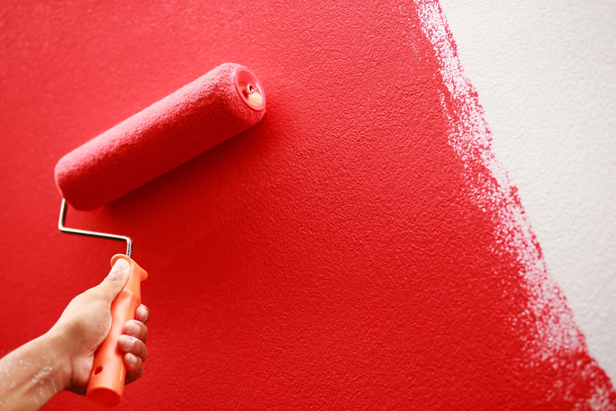Painter is painting the interior wall red in a Pleasanton, CA home