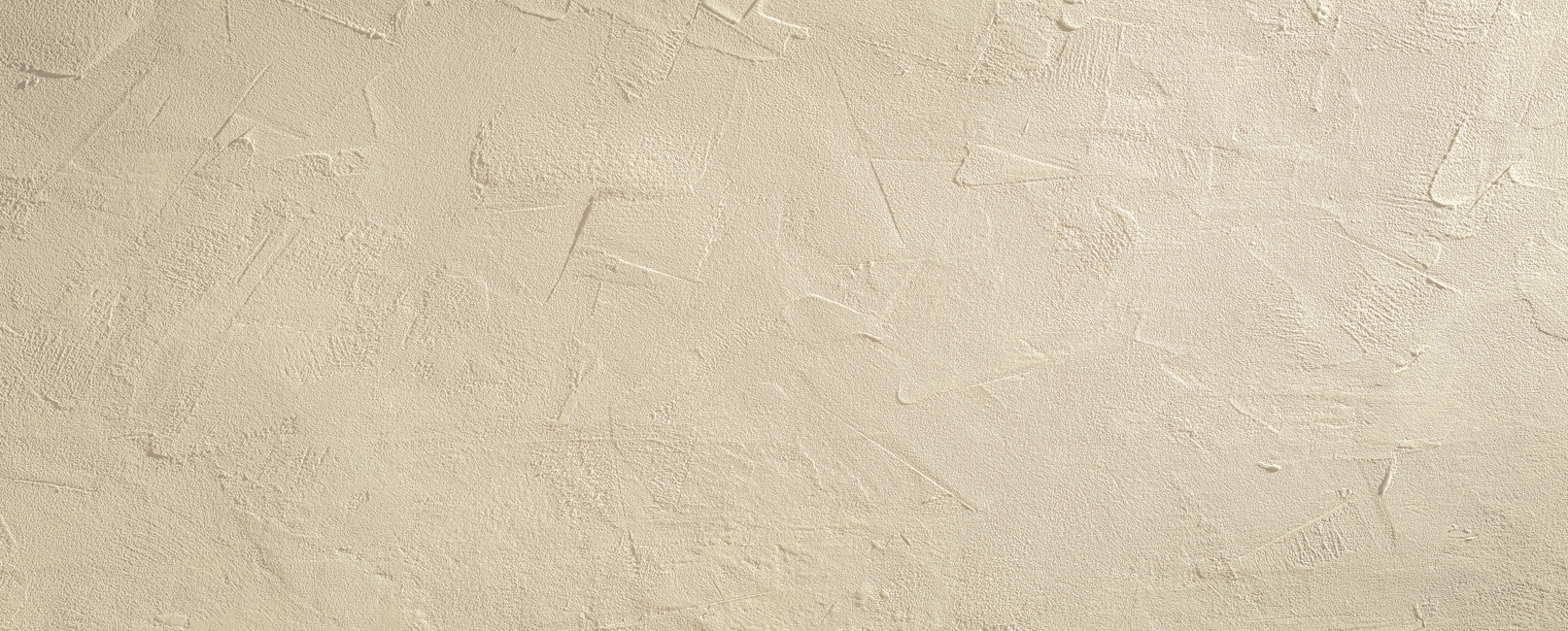 Light beige rough grainy stone or plastered wall texture