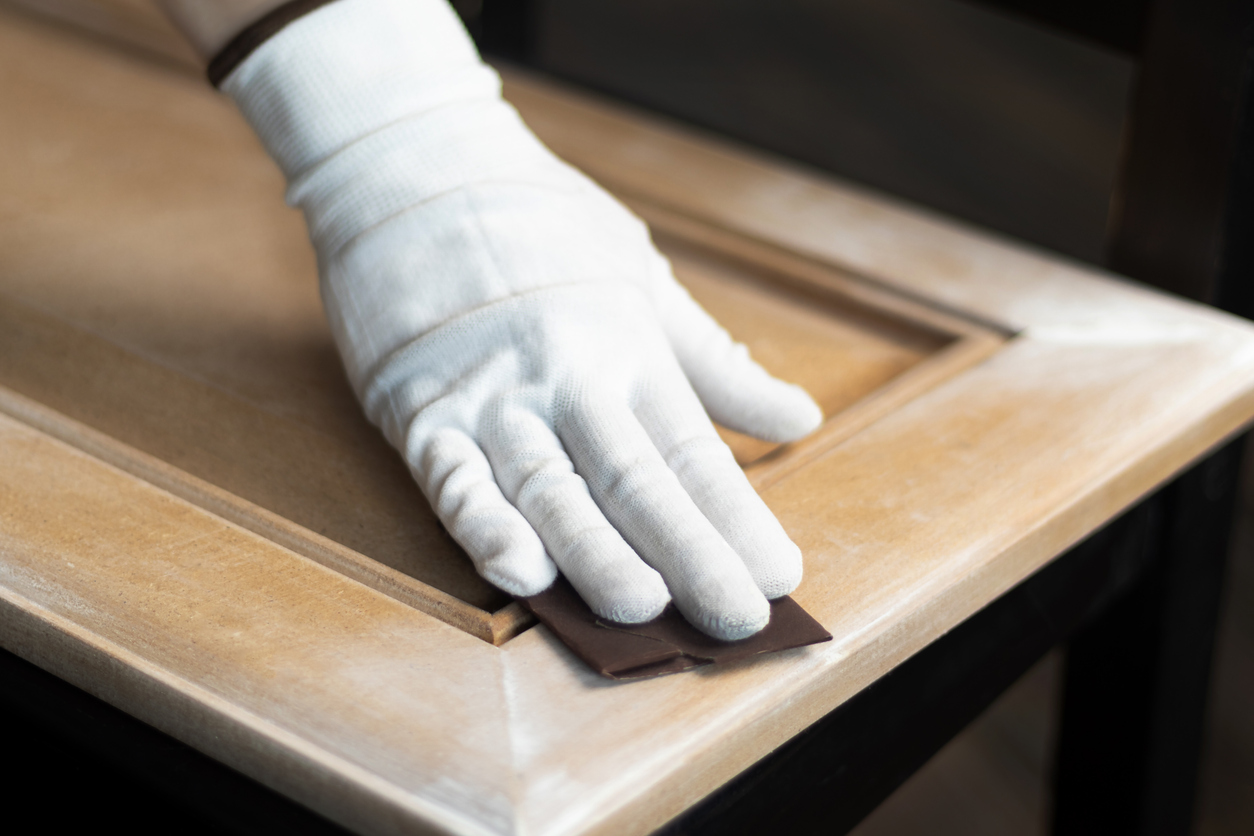Sanding a cabinet door in a Tracy, CA home